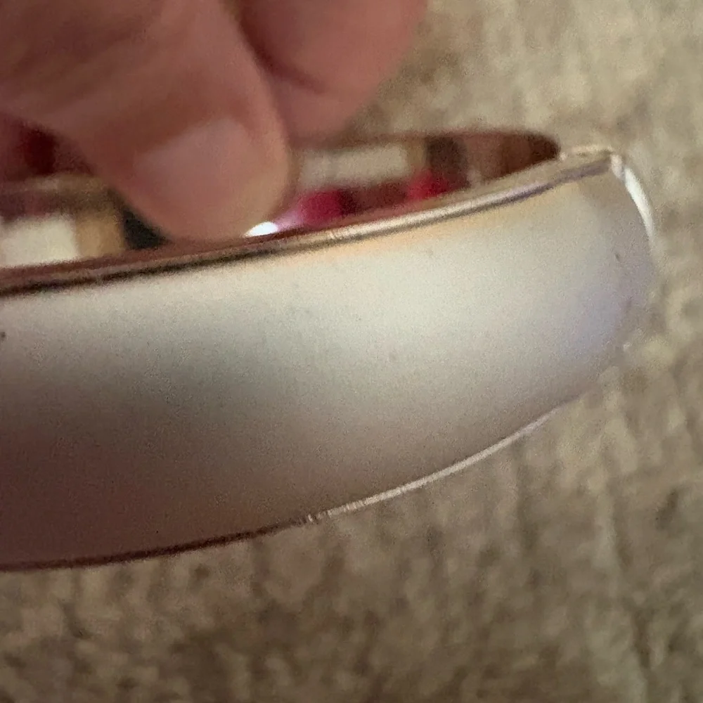 GUC silver tone bangle with safety chain